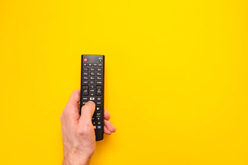 Hand holding tv remote