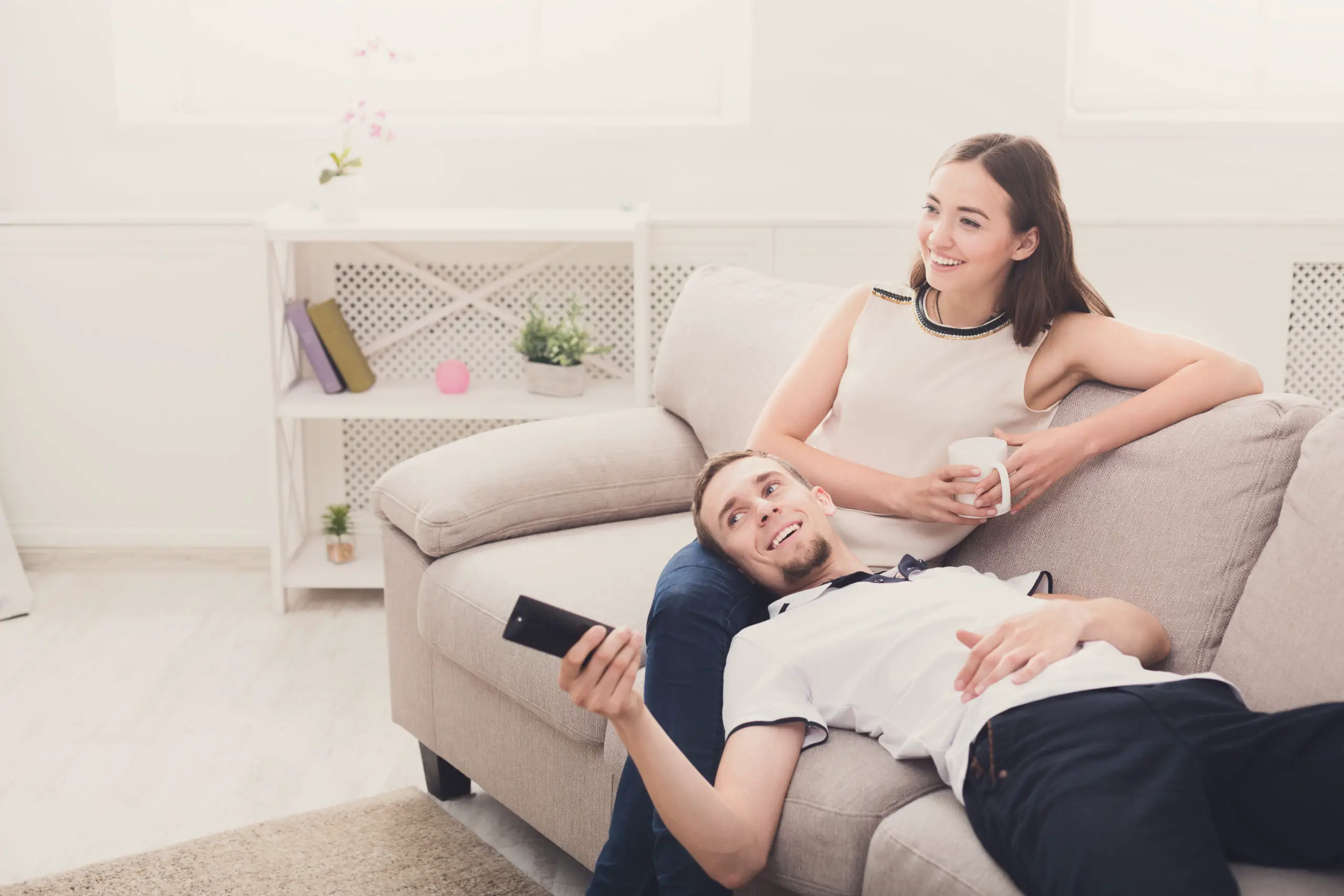 https://elements.envato.com/smiling-young-couple-watching-tv-at-home-PKXLYAS
