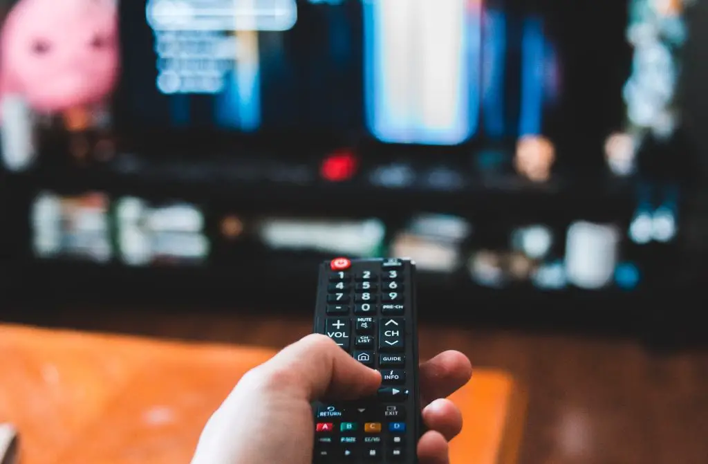 man holding a tv remote