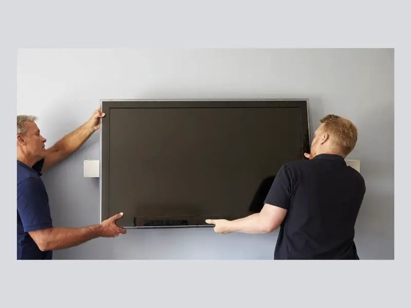 men fitting tv to wall