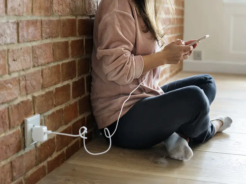 woman on phone whilst it charges